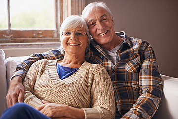 Image showing Senior couple, happy and portrait in sofa with hug, love and connection in living room for retirement. Elderly woman, old man and embrace on lounge couch with pride, care and smile in apartment