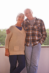 Image showing Senior couple, smile and portrait on balcony with hug, love and outdoor with connection for retirement. Elderly woman, old man and embrace on patio with pride, care and happy at apartment in Germany