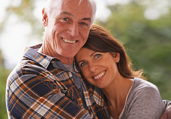 Image showing Senior couple, happy and portrait for hug, love or outdoor in nature with connection for retirement. Woman, elderly man and embrace on patio with pride, care or smile in backyard by trees in Germany