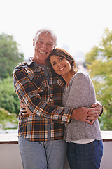 Image showing Senior couple, happy and portrait on balcony with hug, love and outdoor with connection for retirement. Woman, elderly man and embrace on patio with pride, care and smile at apartment in Germany