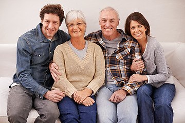 Image showing Couple, elderly parents and portrait on sofa with smile, hug and care with bonding, relax and pride in home. Father, mother and happy with women, men and embrace with love on couch in family house