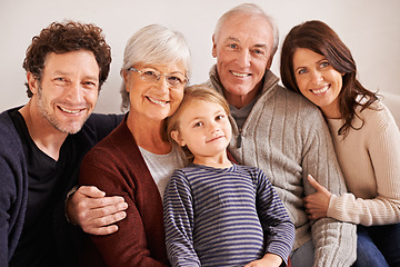 Image showing Grandparents, parents and child on couch for portrait with hug, care or love with generations for bonding in home. Mother, father and senior people with kid for embrace on lounge sofa in family house