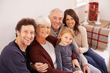 Image showing Grandparents, parents and kid on sofa for portrait with hug, care or love with generations for bonding in home. Mother, father and senior people with child for embrace on lounge couch in family house