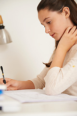 Image showing Teen, girl and book for learning in home, student and homework for assignment or project. Female person, course and schoolwork on weekend, education and knowledge or information by writing at desk