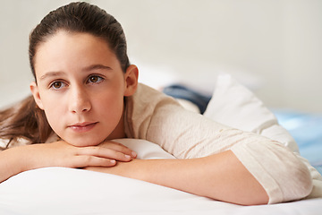 Image showing Girl, relax and thinking on bed in home, tired and peace or calm for waking up on weekend. Female person, pillow and comfortable in bedroom for fatigue or contemplating, blanket and ponder for lazy