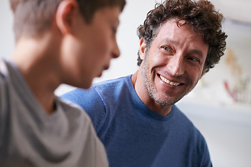Image showing Home, son and father with smile, happiness and proud of child, growth and development of boy. House, adult and man listening to kid talk as parent with love, support and care for family in apartment