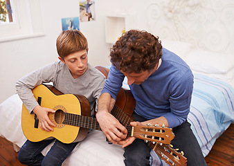 Image showing Guitar, teacher and learning music with child in lesson for development of skill on instrument. Playing, practice and man helping musician kid in education with advice as mentor in acoustic sound
