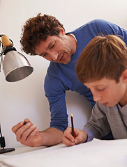 Image showing Study, man and father help son with homework for child, growth and development with education. Parent, guy and male person with support for boy, notebook and writing on table for maths exam or test