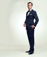 Image showing Portrait, suit and fashion with gentleman, cigarette and stylish clothes on a white studio background. Full body, person and model with elegant outfit and business with leader or smoking with tobacco