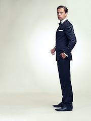 Image showing Man, portrait and suit with cigarette in studio for classy event or retro fashion with vintage tuxedo, white background or mockup space. Male person, face and smoking or cool style, classic or bowtie