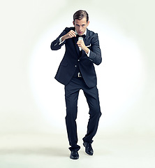 Image showing Business, man and portrait in studio to fight with fists, frustrated, annoyed and aggression or motivation for corporate power. Person, isolated and white background with determination for success