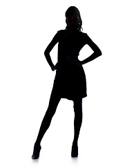 Image showing Silhouette, woman and confidence in studio in fashion dress, pride and heels for glamour by white background. Model, person and hands on hips in mock up for art deco, dark shadow and elegant figure