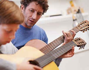 Image showing Learning, guitar and teacher in music with child in lesson and development of skill on instrument. Playing, practice and man helping kid in education with advice as musician mentor in acoustic sound