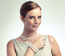 Image showing Portrait, fashion and beauty of woman with pearls in studio isolated on a gray background. Face, freckles and young person in vintage clothes for style, retro or elegance with necklace in Ireland