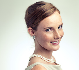 Image showing Portrait, fashion and beauty of happy woman in studio isolated on a gray background mockup space. Face, freckles and skin of young person in vintage clothes for style with pearl necklace in Ireland