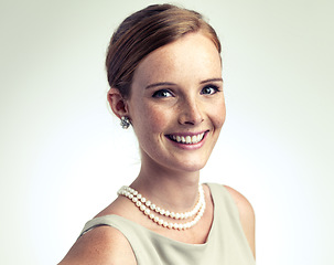 Image showing Portrait, fashion and happy woman in pearl necklace in studio isolated on a gray background mockup. Face, freckles and skin of young person in vintage clothes for style, elegance or beauty in Ireland