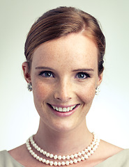 Image showing Portrait, fashion and beauty of happy woman in studio with vintage pearl necklace isolated on a gray background. Face, freckles and skin of young person with smile, style and elegance in Ireland