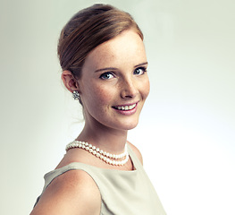 Image showing Portrait, fashion and beauty of happy woman in studio isolated on a gray background. Face, freckles and skin of young person in vintage clothes for style, retro or elegance with necklace in Ireland