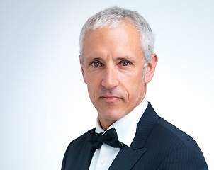 Image showing Portrait, mature man and tuxedo in studio with confidence, designer fashion and stylish in white background. Serious, elegant and male person with pride in suit, fancy and cool style in mockup space