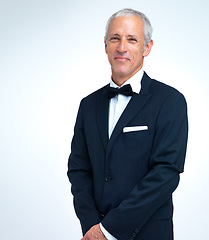 Image showing Mature man, portrait and tuxedo in studio, elegant and designer fashion on white background. Male person, smile and confidence in suit for formal event or party, fancy style and proud of aesthetic