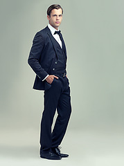 Image showing Man, studio and portrait with rich, vintage and class for retro style and fashion. Gentleman, spy or agent with tuxedo, suit and luxury with confidence for black tie isolated on white background
