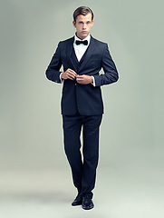 Image showing Gentleman, studio and portrait with rich, vintage and class for retro style and fashion. Man, spy or agent with tuxedo, suit and luxury with confidence for black tie isolated on white background