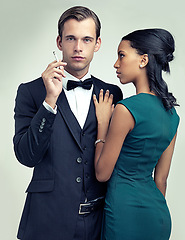Image showing Fashion, smoking and portrait for couple, vintage and style for cosplay and trend for classic and classy. Diverse people and gentleman with girlfriend and cigarette for confident, rich and luxury