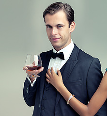 Image showing Man, studio and portrait with wine, luxury and fashion for class or rich retro smile. Gentleman, tuxedo and spy or agent with confidence, style and positive attitude isolated on white background