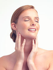 Image showing Face, natural beauty and skincare of woman for glow, shine or health with eyes closed in studio isolated on a white background. Freckles, ginger model and touch skin with cosmetics for dermatology