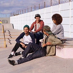 Image showing Skate park, diversity and group with conversation, sunshine and relaxing after training for competition. Multiracial, friends and team on a break, summer and bonding together with skaters in a park