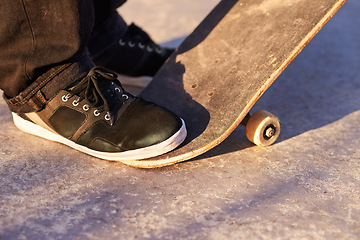 Image showing Closeup, skateboard and person with sneakers, skill and training with technique or fitness. Skater, practice or athlete with energy, sunshine or performance with weekend break, shoes or skating style