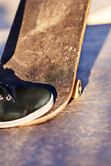 Image showing Closeup, shoes and skateboard with sunshine, person and fitness with performance and talent with skill. Skater, outdoor and summer with sneakers and energy with cardio and balance with recreation