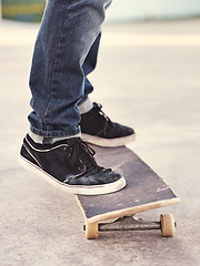 Image showing Closeup, shoes and skateboard with energy, person and fitness with performance and hobby with skill. Skater, outdoor or summer with sneakers, cardio or sunshine with talent or balance with recreation