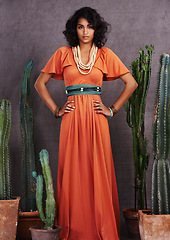 Image showing Indian woman, fashion and confident with jewelry in studio on grey background with cacti props and dress. Portrait, female person and outfit with traditional necklace, trendy and creative look.