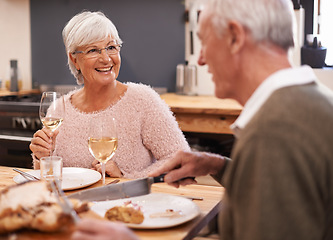 Image showing Elderly couple, food and alcohol for love at table, conversation and healthy meal in home for anniversary. People, bonding and eating together on weekend, relax and speaking on romantic dinner date