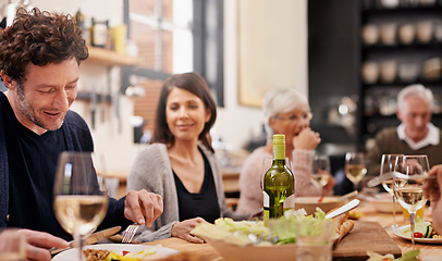 Image showing Smile, eating and family at dinner in dining room for party, celebration or event at modern home. Happy, bonding and group of people enjoying meal, supper or lunch together with wine at house.