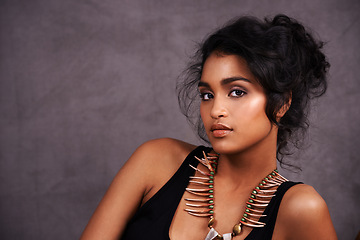 Image showing Indian woman, confident and fashion with jewelry in studio on grey background for heritage or culture. Portrait, female person and beauty with traditional necklaces, outfit and heritage look.