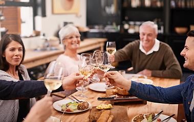 Image showing Cheers, champagne and family at dinner in dining room for party, celebration or event at modern home. Smile, toast and group of people enjoying meal, supper or lunch together with wine at house.