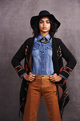 Image showing Fashion, cowgirl or woman confidence in portrait, studio and cool culture or clothing on grey background. Native American person, western and stylish model with pride, boho style and hands on hips