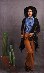 Image showing Cactus, fashion or woman in cowgirl, portrait, wild west culture and cool clothes in studio on grey background. Native American person, western lady and stylish model with pride, boho style or plants