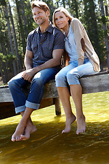 Image showing Couple, lake and happy on pier, nature and sitting with care on vacation, relax or memory in summer. Man, woman and river with smile, trees and bonding with connection for love on holiday in Colorado