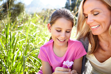 Image showing Smile, girl and mother with flower in nature for childhood development, bonding and relax in field together. Woman, happy and child with plant for vacation, summer holiday or adventure by green grass