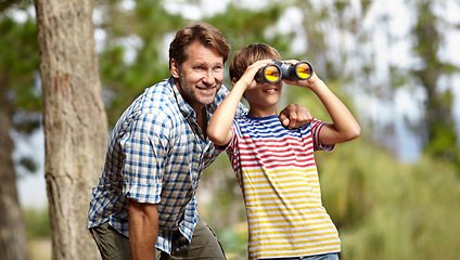 Image showing Father, son and binoculars in forest for outdoor adventure, birdwatching or learning by trees with smile. Dad, child and hug for vision, view and search for connection, care and bonding in woods