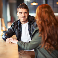 Image showing Couple, hand holding and conversation in restaurant, romance and affection on date. Valentines day, sitting together with love for bonding, female person with boyfriend for trust and compassion