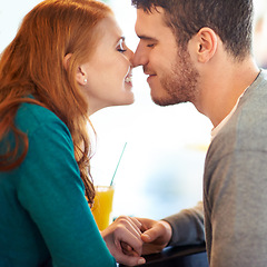Image showing Couple, date and kiss with love, coffee shop or restaurant with happiness together. Man, woman and romance for relationship, care and smile for flirting on break for relax or bonding in cafe