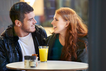 Image showing Couple, smile and eye contact in restaurant with love, romance and affection on anniversary date. Romantic, man and woman in cafe bonding with juice, beverage and laughter in relationship for dating