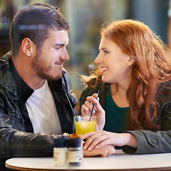 Image showing Couple, holding hands and juice in cafe happy with smile, romance and affection on anniversary date. Romantic, man and woman in restaurant bonding with drink or beverage and joy in relationship