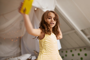 Image showing Girl, child and home with tambourine in portrait for playing, music or learning rhythm in bedroom. Kid, instrument and smile for noise, sound or concert for funny game with creativity at family house