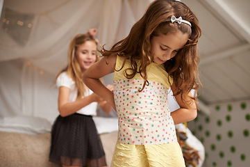 Image showing Young girls, dress up and fun in bedroom of home, clothes and sisters for bonding. Imagine, clothing or creative play with sibling in family house, costume or smile or happy for childhood development