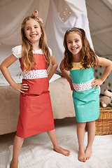 Image showing Fashion, paper and portrait of kids with dress for fun, show or playing together at home. Happy, smile and young girl children friends in gift wrap outfit for style with bonding in bedroom at house.